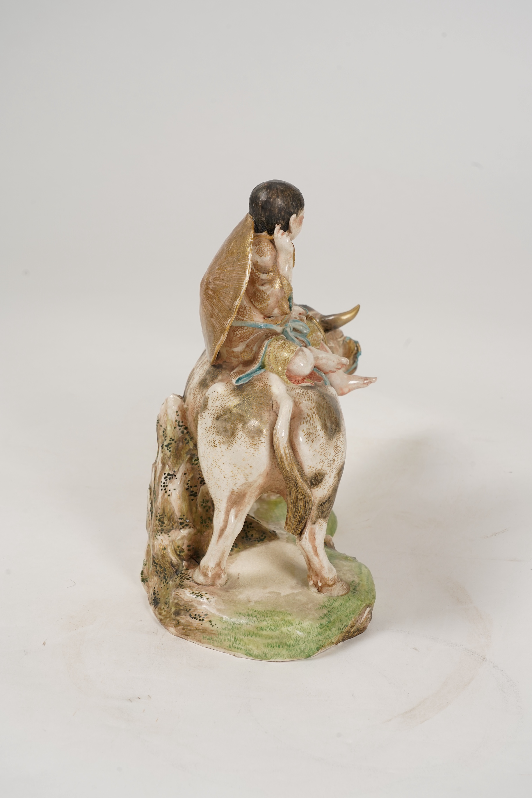 A large Japanese Satsuma model of boy riding on a buffalo, signed Hozan, Meiji period